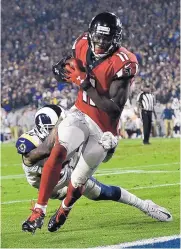  ?? KELVIN KUO/ASSOCIATED PRESS ?? Atlanta receiver Julio Jones (11) scores in the second ahead of Rams defender John Johnson. Jones had nine catches for 94 yards in the game.