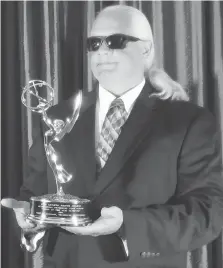  ??  ?? Windsor native Glen McLaughlin holds the Emmy he was awarded for his contributi­on to NBC’s coverage of the Olympic Games in Rio de Janeiro.