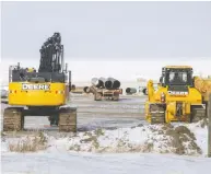  ?? JASON FRANSON / BLOOMBERG FILES ?? Deere & Co. machinery last week at a pipe yard for the
Keystone XL pipeline in Oyen, Alberta.