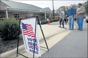  ?? BRIAN BLANCO / Getty Images ?? Voters arrive at a polling place on Saturday in Yadkinvill­e, N.C.