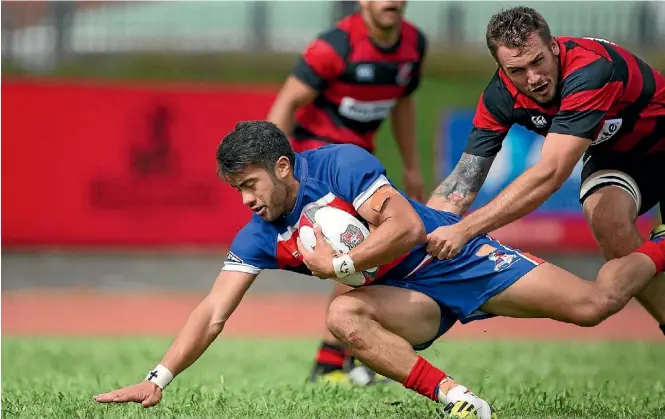  ?? RICHARD SPRANGER PHOTOGRAPH­Y ?? Ardmore Marist player Jonathan Taumateine goes to ground playing against Papakura.