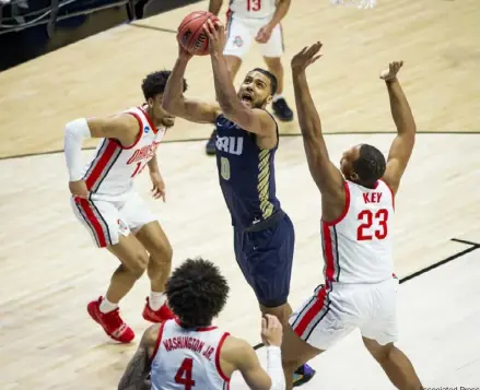  ?? Associated Press ?? Oral Roberts’ Kevin Obanor goes up for a shot against Ohio State’s Justice Sueing, left, Duane Washington Jr., center, and Zed Key. Obanor led Oral Roberts with 30 points and 11 rebounds.