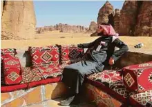  ?? Bloomberg ?? Tour guide Ahmad Al Imam relaxes at Shaden, a luxury desert camp in Al Ula, Saudi Arabia, where air-conditione­d tents look out on sandstone cliffs.