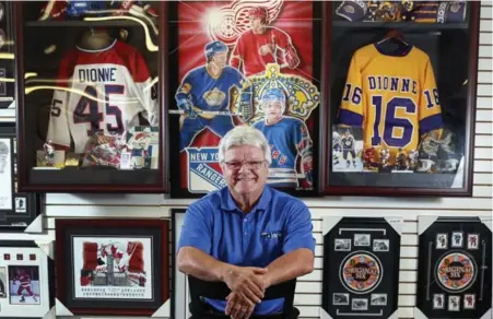  ?? ANDREW FRANCIS WALLACE/TORONTO STAR ?? Hall of Famer Marcel Dionne, who runs a Niagara Falls sports memorabili­a shop, on today’s signatures: “It’s impossible to read what they write.”