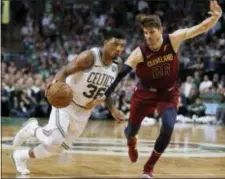  ?? CHARLES KRUPA — THE ASSOCIATED PRESS ?? Boston’s Marcus Smart, left, drives against Cleveland’s Kyle Korver during the second half in Game 2 of the Eastern Conference finals on Tuesday in Boston.