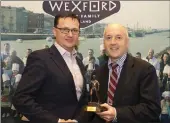  ??  ?? Neil Murphy of Wexford Chedar presents the Wexford Food Champion award to Bill Kelly of Kelly’s Hotel, Rosslare.