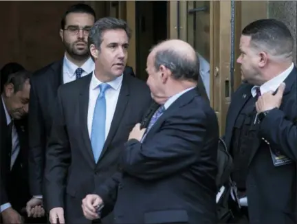  ?? CRAIG RUTTLE — ASSOCIATED PRESS ?? Michael Cohen, center, leaves the federal courthouse in Manhattan following Monday's hearing.