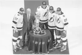  ?? JASON FRANSON/AP ?? The Lightning’s Alex Killorn (17), Victor Hedman, Steven Stamkos and Ryan McDonagh stand with the Prince of Wales trophy after winning the Eastern Conference finals.