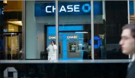  ?? Mark Lennihan/Associated Press ?? A customer leaves a branch of Chase Bank in 2008 in New York.