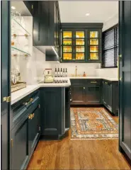  ?? (ALLYSON LUBLOW/BAKES & KROPP VIA AP) ?? This image provided by Bakes & Kropp shows a pantry room with cabinetry in satin-finished Midnight Dream paint. Counters and backsplash are quartz, providing an attractive counterpoi­nt.