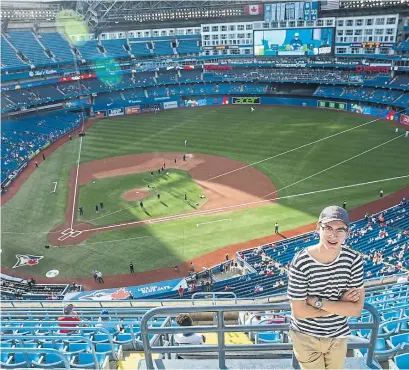  ?? RICK MADONIK/TORONTO STAR ?? American journalism student Jacob Wallace made the Rogers Centre the 12th stop on his 19-stadium journey to explore the connection­sbetween major-league and minor-league ballparks and the surroundin­g rail systems.