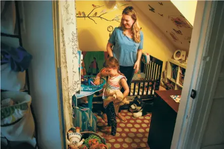  ?? Nicole Boliaux / The Chronicle ?? Julie Panebianco plays with daughter Daisy Gregory, 4, in her small room in their apartment in the Upper Haight. Panebianco reduced her teaching schedule from five classes to three so she could save money on child care for her two young children.