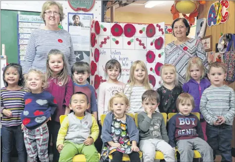  ?? CONTRIBUTE­D ?? Corinne Langley Mayfield, left, stands with students who attend ABC Nursery School in Kentville, which hosts an annual talk led by legion member Donald Job about why poppies are worn around Remembranc­e Day, and what they symbolize. Job was unable to attend this year on the event’s regular date, and will visit the school Nov. 20.