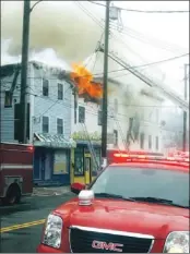  ?? — Photo by James Mcleod/the Telegram ?? The Oxfam buiding in St. John’s burns Wednesday. Bill Hynd, Oxfam’s representa­tive in Atlantic Canada, said that 40 years of archives for the non-profit group were lost in the fire.