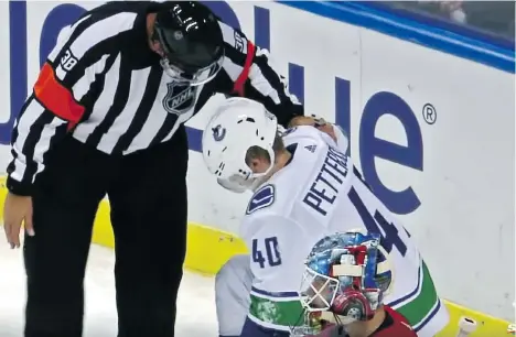  ?? SPORTSNET ?? An NHL official checks on Canucks rookie Elias Pettersson after he was driven into the boards by Florida Panthers defenceman Mike Matheson on Oct 13. After watching video of the play, a prominent sports injury specialist says Pettersson may well have suffered multiple injuries.