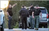  ?? JOHN SPINK — ATLANTA JOURNAL-CONSTITUTI­ON VIA AP ?? Law enforcemen­t work the scene scene following a police chase on Monday in Carroll County, Ga.