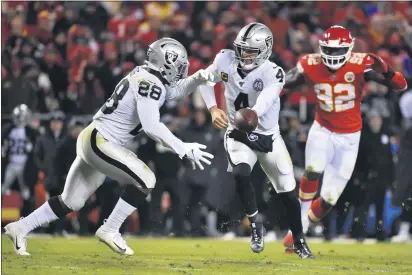  ?? ED ZURGA — THE ASSOCIATED PRESS ?? Kansas City Chiefs defensive end Tanoh Kpassagnon (92) closes in as Oakland Raiders quarterbac­k Derek Carr (4) hands off the ball to running back Josh Jacobs (28) during the second half in Kansas City, Mo., Dec. 1, 2019.