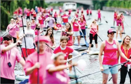  ?? AFP ?? Stand-up paddlers drive on the Alster river during the “Hamburg’s becomes pink” event to raise awareness for breast cancer in Hamburg, northern Germany.