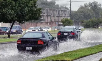  ?? Staff file photo ?? Motorists drive through high water in 2007 in Bellaire. The city failed to file required paperwork with FEMA, meaning some residents will lose flood insurance discounts of about 15 percent.
