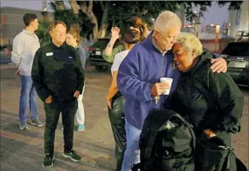  ?? Genaro Molina Los Angeles Times ?? U.S. DISTRICT Judge David O. Carter gives Thee Big Mama a hug before leading an early morning tour of Skid Row in downtown Los Angeles on Friday. Thee Big Mama used to live on Skid Row but now has housing.