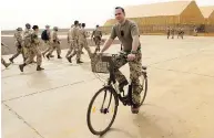  ?? SEAN KILPATRICK / THE CANADIAN PRESS ?? A German soldier rides past Canadian troops en route to a briefing at a UN base in Gao, Mali, on Monday.