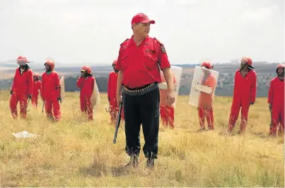  ?? Picture: JAMES OATWAY ?? STAKING A CLAIM: ‘Red Ants’ (private security guards) prepare to remove EFF members from a property where they sought to erect an informal settlement. The party says the government has never found genuine partners for the ‘willing buyer, willing...