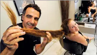  ?? CLIFFORD SKARSTEDT Examiner ?? Cara Armstrong has her 33-inch ponytail lopped off by stylist Michael Arcaro on Friday at Michael Angelo’s on Sherbrooke St. Her ponytail will be donated to Angel Hair and Wigs for Kids.