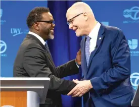  ?? TYLER PASCIAK LARIVIERE/SUN-TIMES ?? Mayoral candidates Brandon Johnson (left) and Paul Vallas (right) shake hands before a mayoral debate at WLS-TV ABC Channel 7.