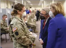  ?? PAUL VERNON — THE ASSOCIATED PRESS FILE ?? Ohio Gov. Mike DeWine, center, and his wife, Fran, right, talk with specialist Emily Milosevic as they tour the Defense Supply Center Columbus in Columbus, Ohio, as members of the Ohio Army National Guard.