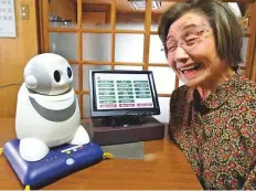  ?? Japan News-Yomiuri ?? Setsuko Saeki chats with her PaPeRo i robot in Saijo, Ehime Prefecture, Japan.