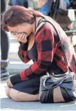  ??  ?? MARCIO JOSE SANCHEZ, AP A woman cries Sunday at the scene of the Oakland warehouse fire. Officials continue to search the charred rubble from the fatal fire.