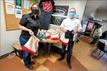  ?? Herald photo by Ian Martens ?? The Salvation Army’s Donna and Donald Bladen were on hand to hand out winter care packages, containing clothing essentials and other items for the cold winter months, during the Tuesday lunch service at the Lethbridge Soup Kitchen. @IMartensHe­rald