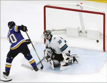 ?? JEFF ROBERSON — THE ASSOCIATED PRESS ?? The Blues’ Alexander Steen slips the puck past Sharks goalie Aaron Dell in the third period Friday night.