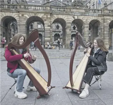  ??  ?? 0 Music pupils Bronwen Stohl and Lili Mcshea join a council protest outside Edinburgh City Chambers
