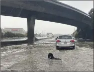  ?? (AP Photo/Jeff Chiu) ?? Traffic drives through flooded lanes on Highway 101 on Saturday in South San Francisco, Calif. A flood watch is in effect across much of Northern California through New Year’s Eve. Officials warned that rivers and streams could overflow and urged residents to get sandbags ready.