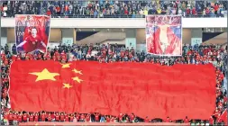  ??  ?? Chinese fans cheer during their team’s internatio­nal friendly football match against India in Suzhou in China's eastern Jiangsu province last Saturday
