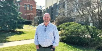  ?? ROBERT HERGUTH/SUN-TIMES ?? Timothy Nockels, who says he was molested as a boy by the Rev. John Baptist Ormechea when the priest was assigned to Immaculate Conception Parish. The Norwood Park church and the former Passionist monastery are in the background.