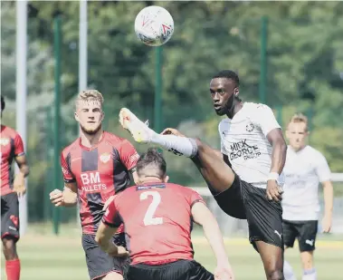  ??  ?? Mo Eisa in high-kicking action for Posh against Kettering..