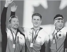  ?? JEFF MCINTOSH/THE CANADIAN PRESS FILES ?? The Canadian trio of Ted-Jan Bloemen, left, Ben Donnelly and Jordan Belchos celebrate winning gold in the men’s team pursuit at a World Cup event in November.