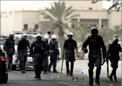  ?? AP/HASSAN AMMAR ?? Bahraini riot police move against anti-government protesters outside Manama on Saturday.