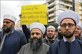  ?? BILAL HUSSEIN / AP ?? In front of the Russian embassy in Beirut, Lebanese Sunni clerics protest Sunday in solidarity with residents of the Syrian capital’s eastern suburb of Ghouta. The Syrian capital and its embattled suburbs were relatively calm Sunday.