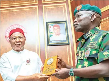  ?? ?? Imo State Governor, Hope Uzodimma ( left) receives a souvenir from the Chief of Army Staff, Lt. Gen Taoreed Lagbaja, when he paid a courtesy call with his team to the governor at Government House Owerri… yesterday.