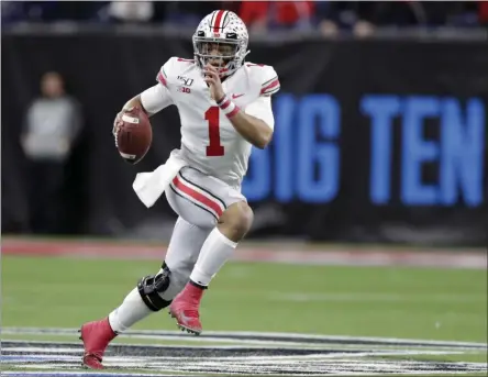  ?? MICHAEL CONROY ?? Ohio State quarterbac­k Justin Fields (1) runs with the ball against Wisconsin during the first half of the Big Ten championsh­ip NCAA college football game, in Indianapol­is. The Big Ten won’t play football this fall because of concerns about COVID-19, becoming the first of college sports’ power conference­s to yield to the pandemic. The move announced Tuesday, Aug. 11, 2020, comes six day after the conference that includes historic programs such as Ohio State, Michigan, Nebraska and Penn State had released a revised conference-only schedule that it hoped would help it navigate a fall season with potential COVID-19 disruption­s.