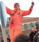  ?? OKLAHOMAN ARCHIVES ?? Mr. Orange Power, Lee Redick, takes video of the crowd at the Walk before the Bedlam college football game in 2011.