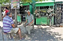  ??  ?? Spare parts sellers sit around waiting for business