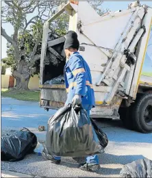  ?? Pictures: JUDY DE VEGA ?? HEAVY LOADS: An NMBM rubbish collector on his rounds in the city’s suburbs