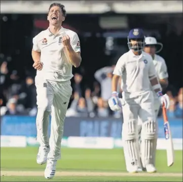  ??  ?? Chris Woakes celebrates the crucial wicket of India captain Virat Kohli during the second day of the second Test at Lord’s on Friday.