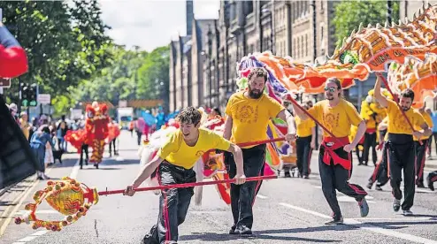  ?? ?? Colourful The Perthshire Jubilee Mela on Sunday June 5, 2022 saw a parade, musicians and food stalls set up in the North Inch park of Perth. Pictures by Chris Logan