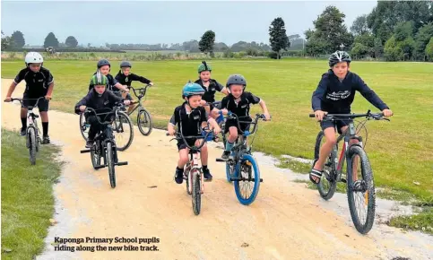  ?? ?? Kaponga Primary School pupils riding along the new bike track.