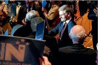  ?? PHOTO: MAARTEN HOLL/FAIRFAX NZ ?? .Bill English is greeted by supporters at the National Party Conference, where he closed out a bad week with promises of more tax cuts.